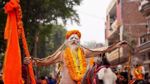 A sadhu, or Hindu saint, rides a horse during the Mahanirvani Akhada religious procession ahead of the Maha Kumbh Mela festival in Prayagraj, January 2, 2025. (Photo Credit: HIMANSHU SHARMA/AFP) (Photo Credit: HIMANSHU SHARMA/AFP via Getty Images)