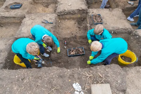 Suffolk County Council Children taking part at a dig in Rendlesham, Suffolk