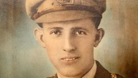 A colourised sepia picture of a man wearing World War One uniform. 