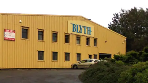 A google street view image of a yellow factory unit with a large sign saying Blythe below the roof