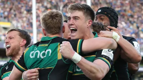 Tommy Freeman, of Northampton Saints, celebrates with a group of his teammates at the Aviva Stadium in Dublin.