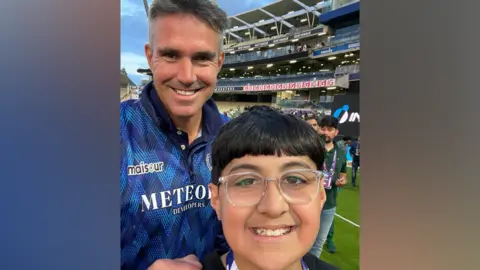 Family Youngster Husayn standing with former England international Kevin Pietersen at Edgbaston