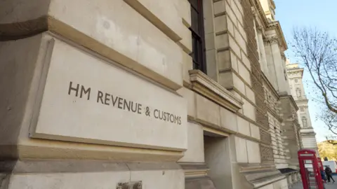 Getty Images The HMRC building in Whitehall, London, showing the white Portland stone side and a close up of the HM Revenue and Customs sign