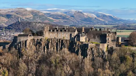 Kevin Hamill Stirling castle with the Wallace monument and snowy Ochil hills in the background.