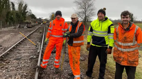 Four members of the permanent way team standing side by side