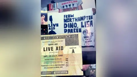 Dino Vescera A picture of the Live Aid ticket and a banner which says "From Northampton Dino, Lisa Darren"