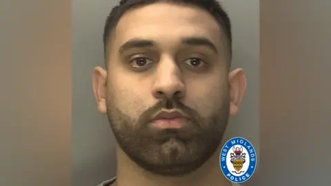 West Midlands Police A police mugshot of a man with short dark hair and a short dark beard. He is looking directly at the camera with a plain background behind him.