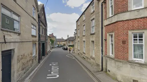 Google maps Union Road in Chippenham. It is a small, lane-like road with business premises either side. There is a small pavement on the right hand side.