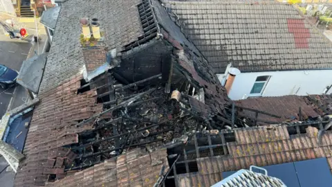 Aerial view of a fire-damaged tile roof
