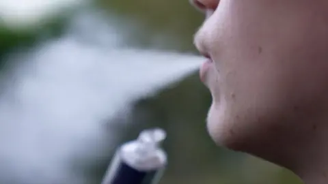 Close up of a teenager smoking a vape