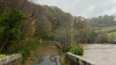 Alex B Road flooded next to flooded fields in Devon