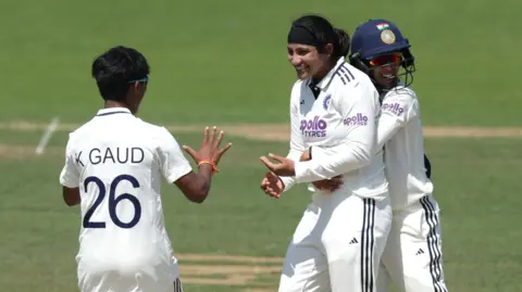 India's Sneh Rana (centre) celebrates the wicket of England's Sophie Ecclestone that secures victory at Lord's