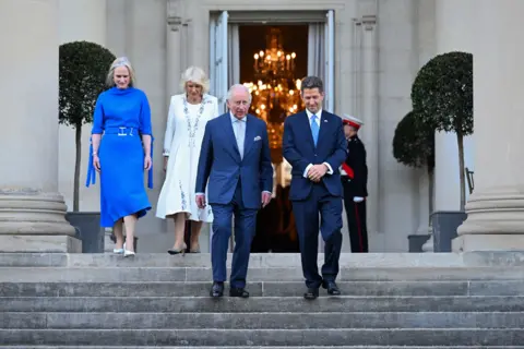 Samir Hussein / PA Media Claire Turner, Queen Camilla, King Charles III and Sir Christian Turner, British ambassador to the US, attend the garden party at the British Embassy in Washington DC.