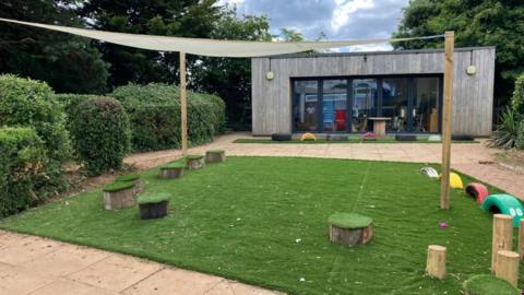 The new garden area consisting of a large atroturf square with toadstools and mutli coloured tyres in it.