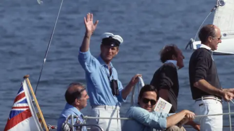 Getty Images Prince Philip waving from a yacht