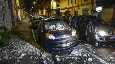 EPA Rubble on a car in a narrow street in Pozzuoli near Naples