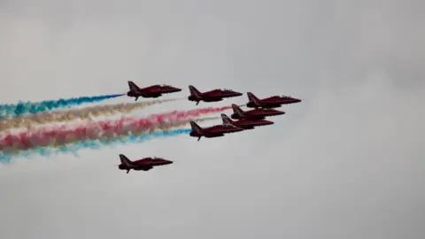 Dave Hancocks Seven red arrows flying in formation, spouting red, blue and white smoke