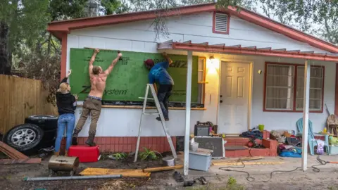  Cristóbal Herrera/EPA-EFE People boarding up   windows to hole   for Hurricane Helene, successful  Old Town, Florida 
