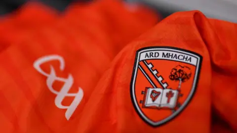 An orange shirt with the crest of Armagh and the logo of the GAA