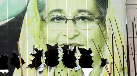     Photo of Sheikh Hasina with a hole in it EPA-EFE/REX/Shutterstock