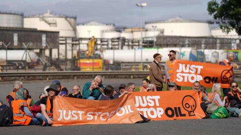 People take part in a Just Stop Oil protest blocking the entrance to the Kingsbury Oil Terminal near Birmingham. Picture date: Wednesday September 14, 2022. 