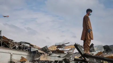 Reuters A man walks at the site of a drug users rehabilitation hospital destroyed in what the Taliban said was a Pakistani air strike in Kabul, Afghanistan, March 17, 2026.