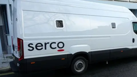 Getty A large white custody van parked in a street. It has "Serco" printed in black letters on its side.
