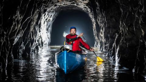 A canoeist inside a tunnel