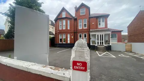 LDRS Life Wirral - a victorian style building set at the back of a forecourt- a post on the wall at the entrance reads No Entry