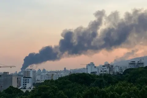 Getty Images Smoke billows from the Tehran skyline as the Islamic Republic of Iran Broadcasting (IRIB) building has been hit by Israeli attack