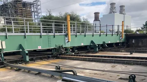 Network Rail Close-up of green metal barriers going across metal tracks