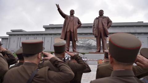Service personnel pay tribute to the statues of late North Korean leaders Kim Il Sung and Kim Jong Il on Mansu Hill in Pyongyang on July 7, 2024