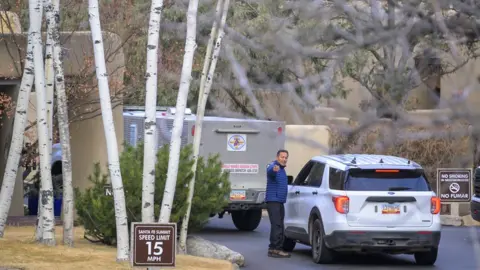 AP SINGLE USE ONLY! Sheriff deputies arrive at the Santa Fe Summit gated community where actor Gene Hackman and his wife Betsy Arakawa passed away