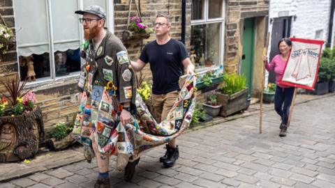 The Coat of Hopes arrives in Haworth