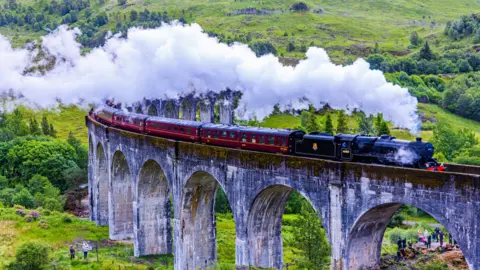 The Jacobite steam train going over the Glenfinnan Viaduct