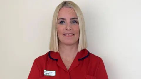MANX CARE Regan Baggley, who has blonde hair, and IS wearing a red uniform.