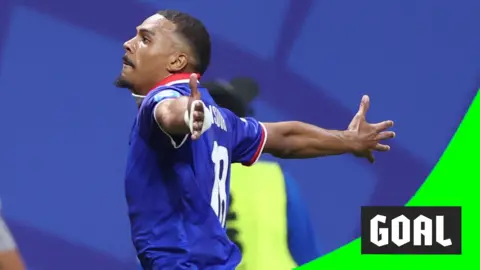 Wilson Isidor runs to the crowd with his arms wide open to celebrate scoring a second goal for Haiti