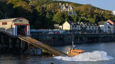 Manx Scenes A lifeboat crashes into the water after sliding down the now disused lifeboat slipway. 