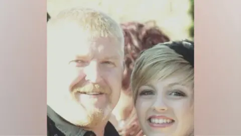 Family photo An older picture of Hayley's stepdad Lee Murphy on the left, he has blonde hair and a goatee and Hayley, who has blonde hair, smiling on the right.