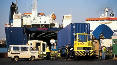 Portsmouth International Port Freight boxes are unloaded from a vessel at the dockside in another vintage picture.