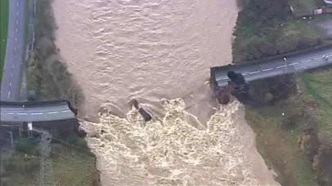 BBC TV News The collapsed Northside Bridge is pictured by a BBC TV News Helicopter in Workington, in Cumbria, northen England, on November 20th, 2009. 