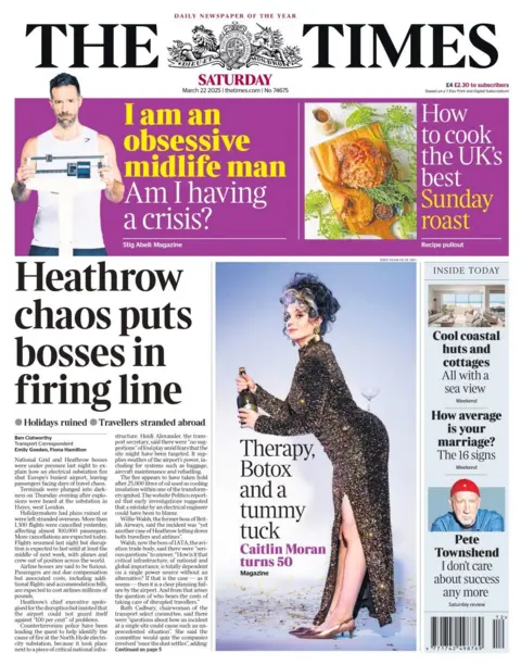 A front page of The Times shows a headline that reads: Heathrow chaos puts bosses in firing line. Next to it, an image of a woman in a dress with a slit poses with a martini on her behind. She is popping champagne, and below her the headline reads: Therapy, Botox and a tummy tuck. Caitlin Moran turns 50. 