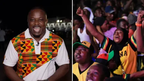 A man speaks to the camera at night, wearing a white shirt with colourful patterns across most of it.
