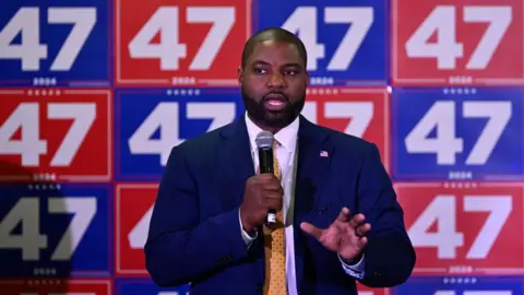 US Rep Byron Donalds, endorsed by Trump, is running for Florida governor. He stands in front of Trump 2024 campaign signs that read "47" -- a reference to Trump being the 47th US president.