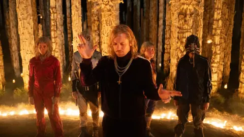 Sony Images Erin Kellyman, wearing red, and Jack O'Connell, centre, in 28 Years Later: The Bone Temple 