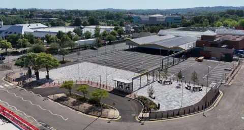 City of Wolverhampton Council A aerial view of the new-look Bilston outdoor market. There is a large canopy, car parks and other areas in view. 