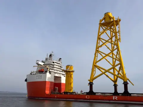 A large yellow tower on board a ship in Leith.