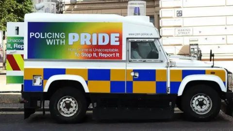 Getty Images A sideways view of a police landrover which has the slogan 'Policing with Pride' painted on in rainbow colours at the Belfast Pride event in 2017. 
