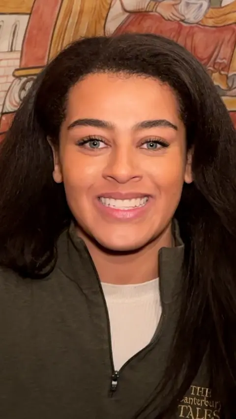 A woman smiling at the camera 