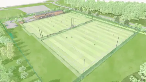 Rendered aerial view of two adjacent, fenced‑in football pitches surrounded by trees, with floodlights, a nearby building and a small car park connected by paths and a road.